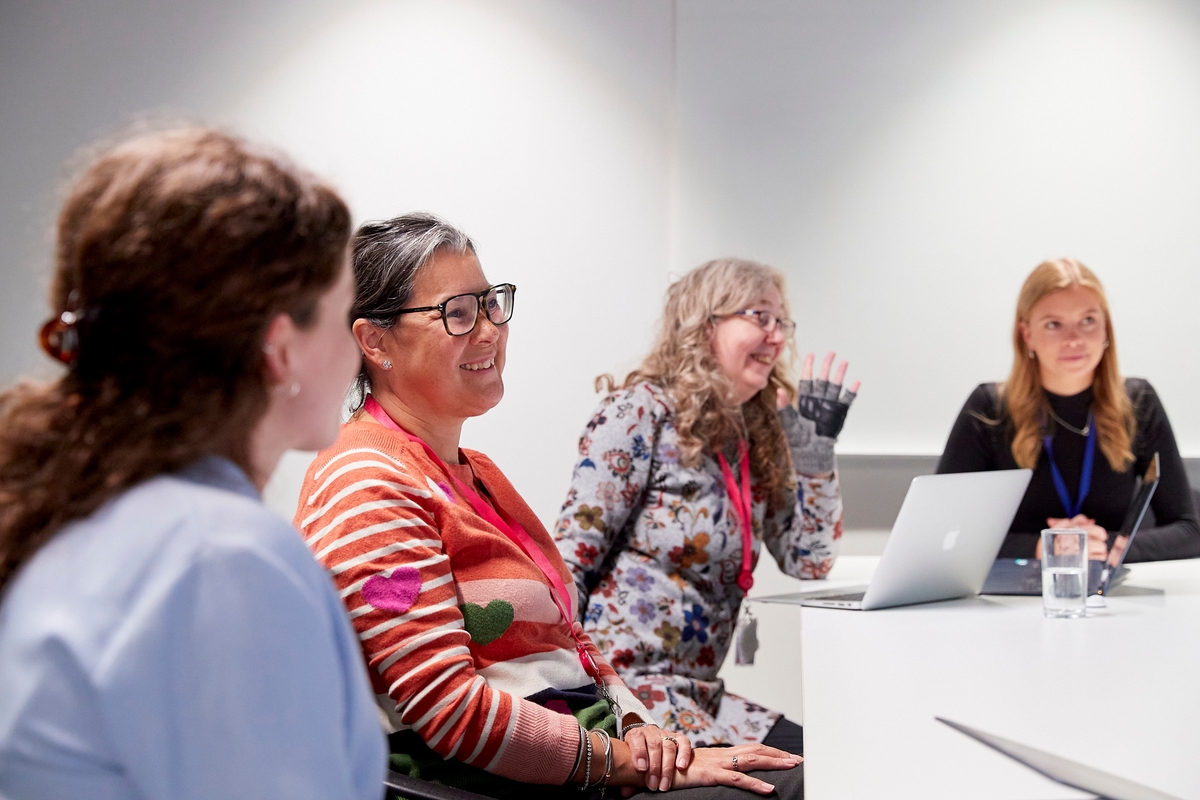 Four patient representatives in a meeting.